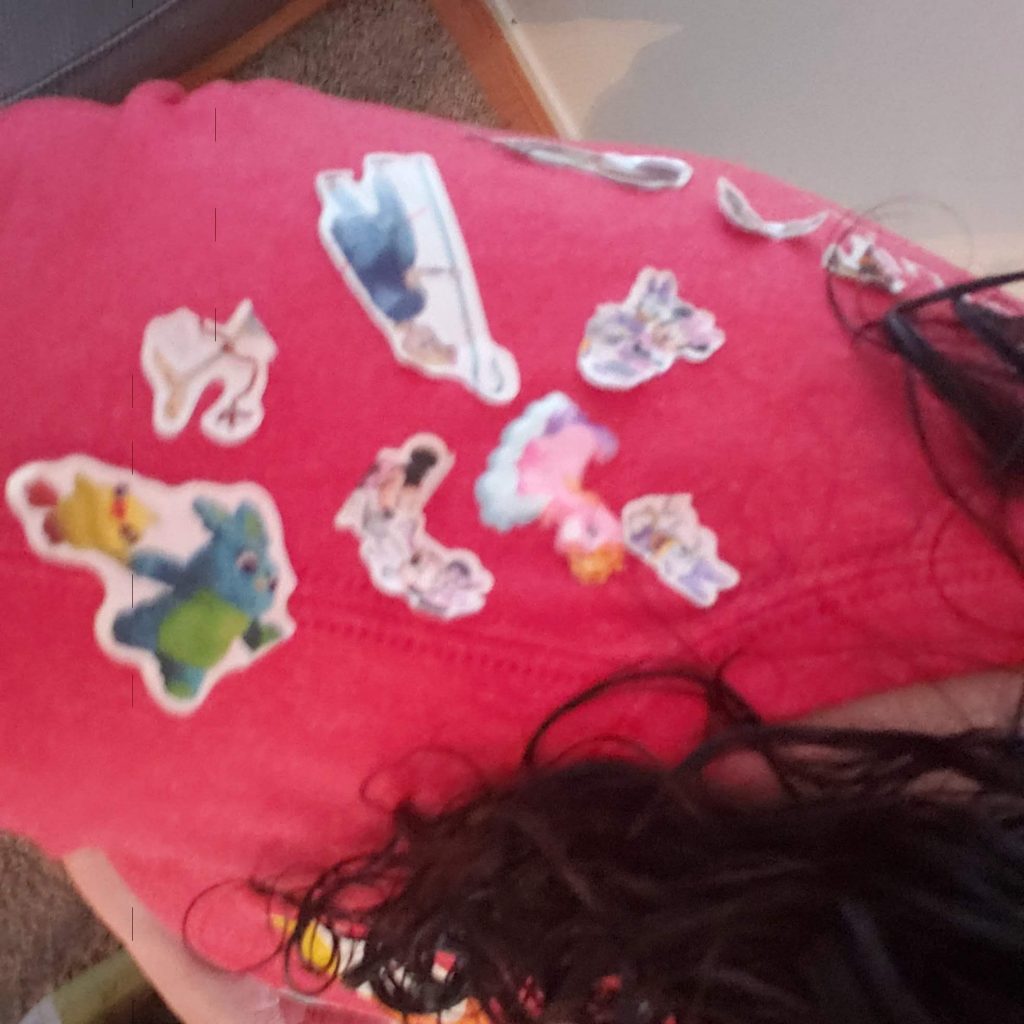 A red shirt covered in Toy Story stickers