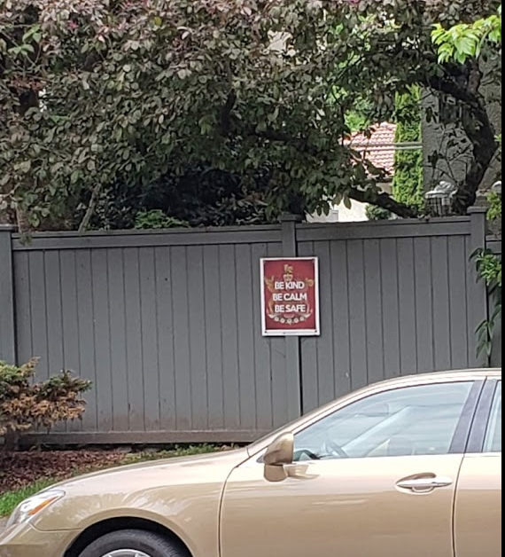 A poster on a wall that says "be kind. Be calm. Be safe."