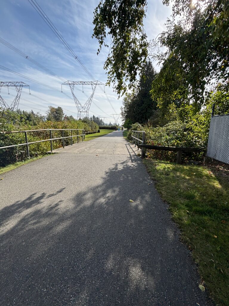 The paved walking path of Serpentine Greenway (photo by Jennifer Hayward, 2025).
